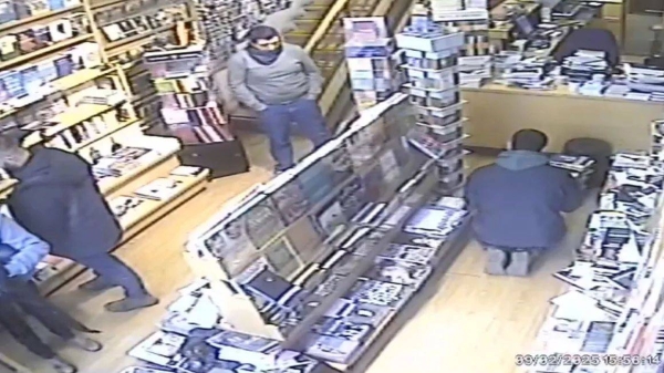 CCTV footage of the raid shows men flicking through books and putting them into trash bags. 