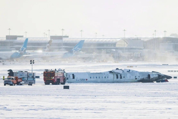 The wreckage of a Delta Air Lines-operated Bombardier CRJ900 aircraft lies upside down Tuesday on a runway of Toronto Pearson International Airport. C