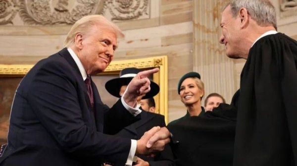 Donald Trump shakes hands with US Supreme Court Chief Justice John Roberts at the president's inauguration in January