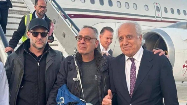 George Glezmann (centre) pictured at Kabul airport before boarding a flight to Qatar