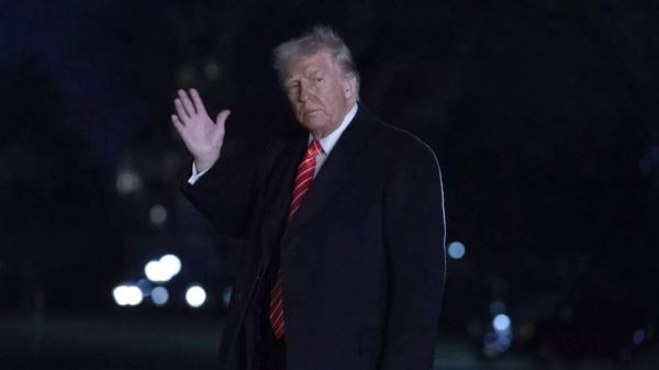President Donald Trump waves to the media as he walks on the South Lawn of the White House, in Washington, Saturday, March 22, 2025