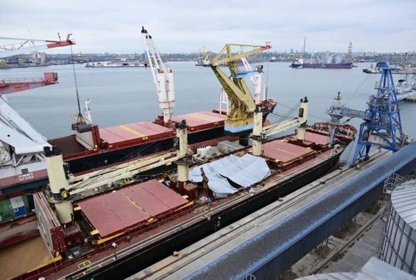The destroyed hatch of the grain cargo ship 'AYA' is covered by a foil in the Black Sea port of Constanta September 19
