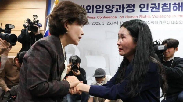 The commission's chairperson Park Sun-young (left) comforted adoptee Yooree Kim (right) during an emotionally charged press conference