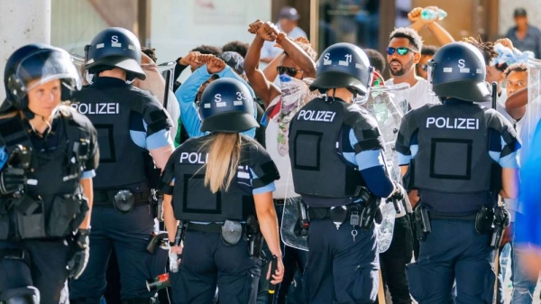A group of people is surrounded by police forces after riots at an Eritrea event in Stuttgart, Germany, 16 September 2023