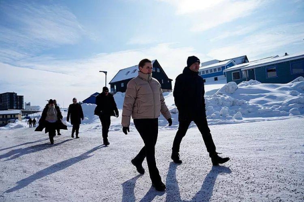 Denmark's Prime Minister Mette Frederiksen accompanied by Greenland's Acting Head of Government, Múte B. Egede walk on a street in Nuuk, Greenland, Wednesday, April 2, 2025
