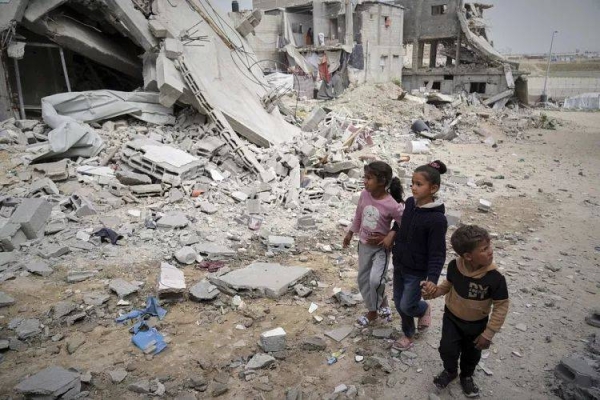 Children walk by the destroyed house of journalist Islam Meqdad, where she was killed along with her son and five other family members in an Israeli army strike, April 6, 2025