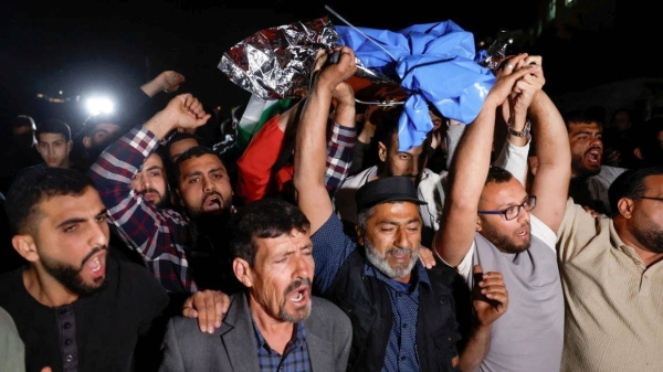 Palestinians carry the body of a Palestinian-American boy who was killed by Israeli forces in the village of Turmusaya, near Ramallah in the occupied West Bank on April 6, 2025