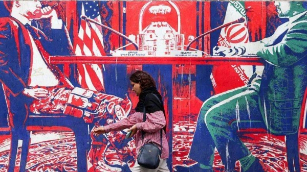 A mural on the wall of the former US embassy in Tehran depicts the Iranian government's view of negotiations with the US