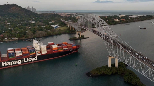 A cargo ship sails under Las Americas bridge through the Panama Canal, in Panama City, on March 13