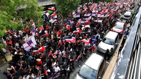 Members of the Maori community and their supporters march through the streets in a protest rally to criticize the government for its policies affecting the Indigenous Mori population in Wellington