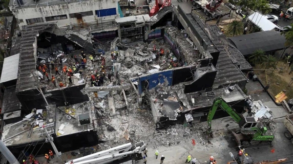 Rescue teams work at the Jet Set nightclub on Wednesday, a day after its roof collapsed killing at least 221 people in an incident that sent shockwaves around the country