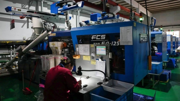 A staff member works at the production line of a communication connector company in Beilun District of Ningbo City, east China's Zhejiang Province, April 9, 2025