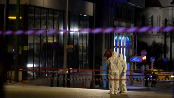 Police investigators inspect the site after a bomb explosion outside of the Hellenic Train offices in Athens, 11 April 2025