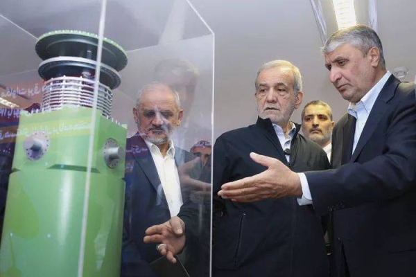 In this photo released by the Iranian Presidency Office, President Masoud Pezeshkian, second right, listens to head of Atomic Energy Organization of Iran Mohammad Eslami