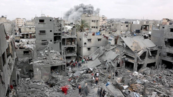 Palestinian rescuers check the site of Israeli bombardment on a residential building in Gaza City's Shujaiyya neighborhood on April 9