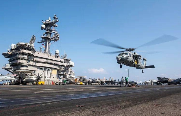 An MH-60S Sea Hawk helicopter hovers over the USS Carl Vinson aircraft carrier while operating in the Middle East, 12 April, 2025