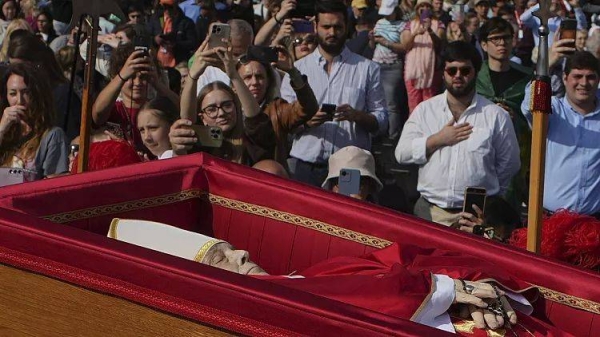 The body of Pope Francis is carried into St Peter's Basilica at the Vatican, where he will lie in state for three days