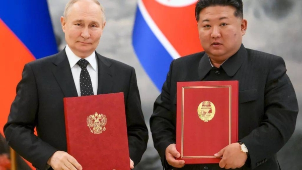 Russian President Vladimir Putin and North Korea's leader Kim Jong Un pose for a photo during a signing ceremony of a new partnership in Pyongyang, North Korea, June 19, 2024