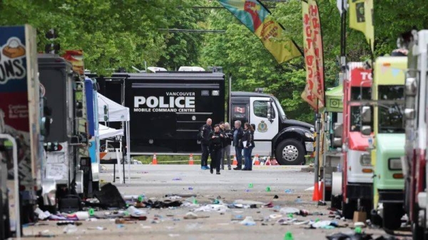 Police officers work at the scene, the morning after a vehicle was driven into a crowd at a Filipino community Lapu Lapu Day block party, in Vancouver.