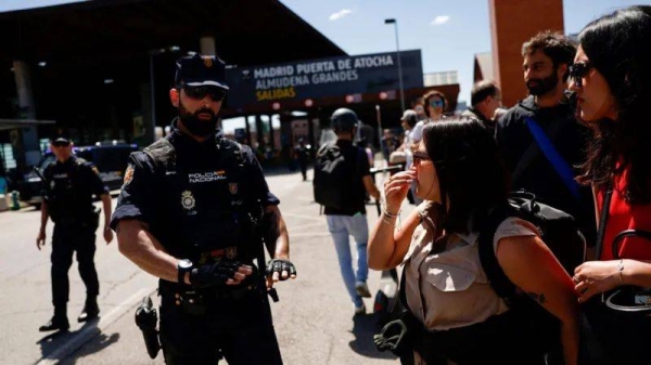 Police tell travelers that Madrid's Atocha train station is closed due to the outage