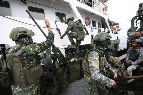 Philippine marines board a ship during a joint visit, board and seizure exercise with their US and South Korean counterparts with members of Japan's Self-Defense Forces as observers, during training in Ternate town, west of Manila