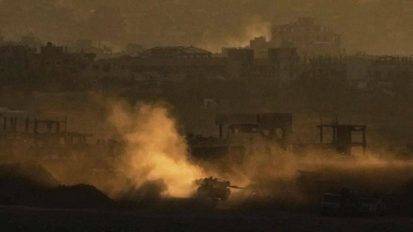 An Israeli army tank maneuvers in the Gaza Strip is seen from southern Israel on May 4