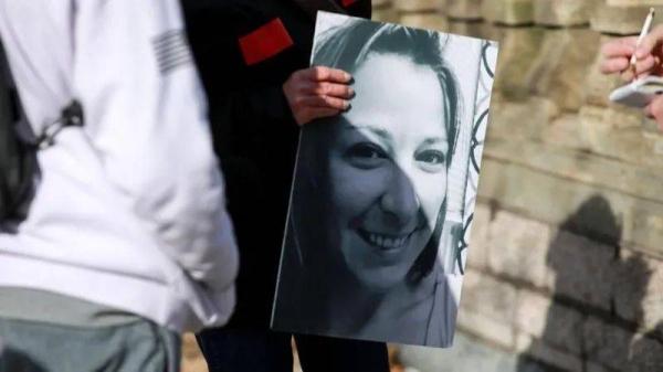 A protester holds a photo of Ashli Babbitt