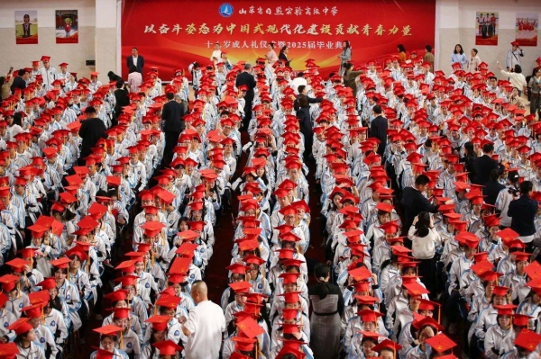 Students in China's Shandong province participate in a graduation ceremony earlier this month. The vast majority of Chinese students who attend university continue their studies in China