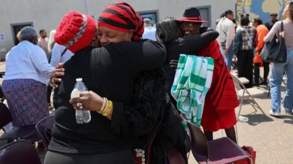 Attendees of a morning church service embrace each other