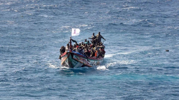 Migrants crowd a wooden boat as they sail to the port in La Restinga on the Canary island of El Hierro, 18 August, 2024