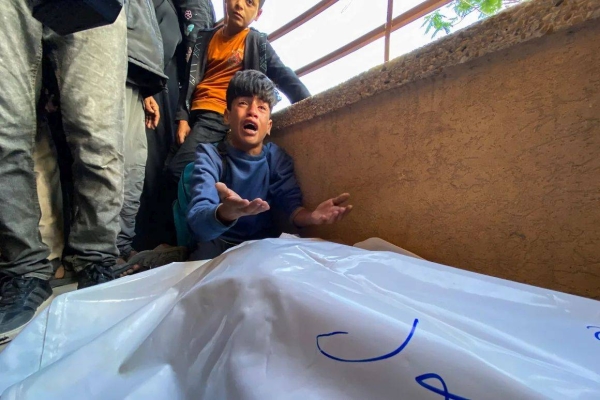 A Palestinian boy mourns loved ones who were killed by Israeli fire, as they gathered to try and access food near a US-backed aid center in Rafah, at Nasser Hospital, in southern Gaza, on June 3