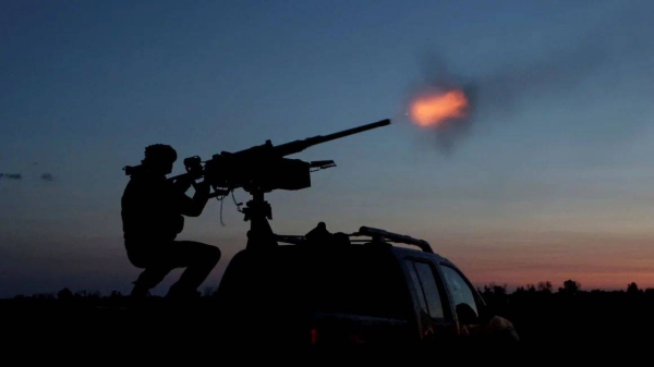 A Ukrainian Armed Forces serviceman fires a machine gun towards a Russian drone in the Kharkiv Region of Ukraine on June 2