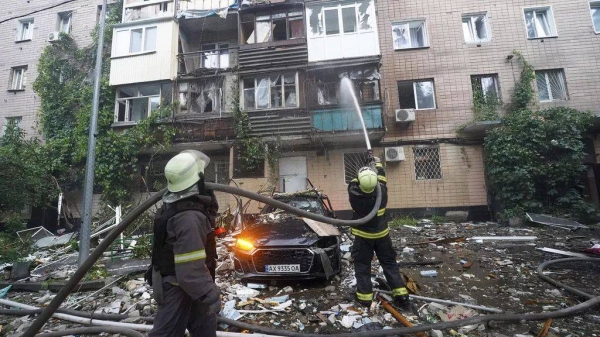 Firefighters on the scene of an apartment building hit by Russian airstrikes in Kharkiv, Ukraine,