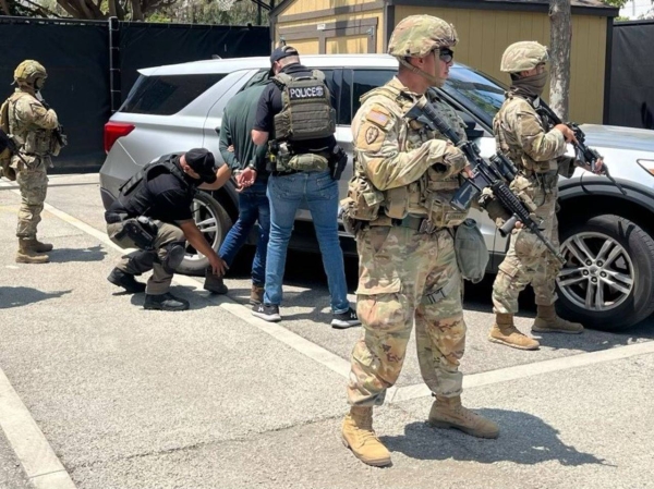 Members of the National Guard guard Immigration and Customs Enforcement officers during an operation in Los Angeles, in this image shared by ICE on Tuesday.