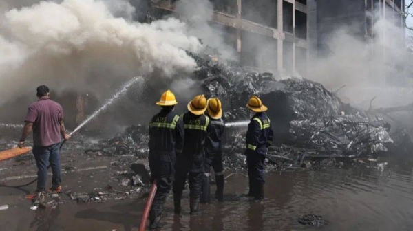 Firefighters work to put out a fire at the site where an Air India plane crashed in Ahmedabad, India, June 12, 2025
