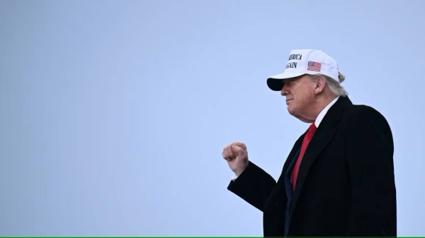 President Donald Trump raises a fist as he steps off of Air Force One upon arrival at Calgary International Airport, before the start of the G7 summit, in Calgary, Alberta, Canada, on June 15