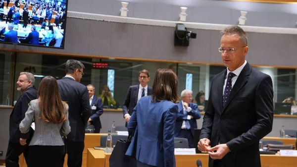 Hungary's Foreign Minister Peter Szijjarto, right, arrives for a round table meeting of EU foreign ministers at the European Council building in Brussels, Monday, June 23, 202