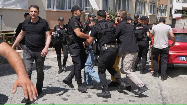 A person is detained by Turkish police officers as he tries to gather with others to celebrate the annual LGBTQ  Pride March, in Istanbul, Turkey, on Sunday.