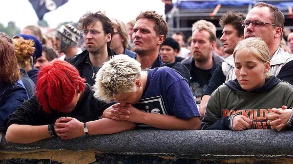 Young people grieve and pray during a memorial service held by the bishop of Roskilde, Jan Lindhardt, Saturday, July 1, 2000