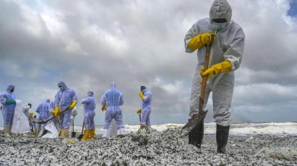 Sri Lankan Navy soldiers work to remove nurdles and other debris on a beach in Colombo after the X-Press Pearl disaster.