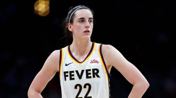 Caitlin Clark with her hands on her hips, wearing a jersey for her team