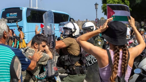 Riot police scuffle with pro-Palestinian protesters during the departure of a cruise ship carrying Israeli tourists on the southeastern Aegean Sea island of Rhodes, 28 July