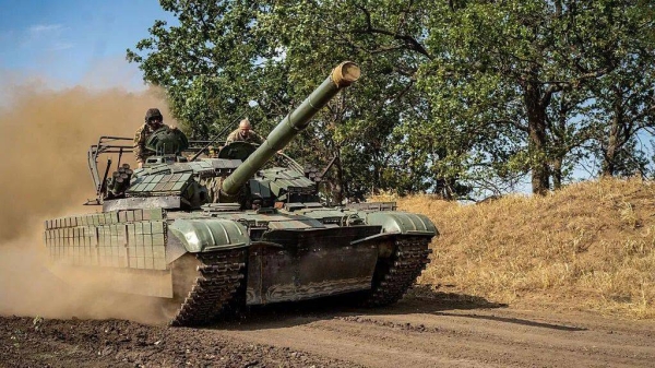 Dust rises as a Ukrainian soldier drives a tank down a dirt road in Kherson, Ukraine on 8 August