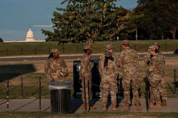 Troops seen standing with the US Capitol building in the background