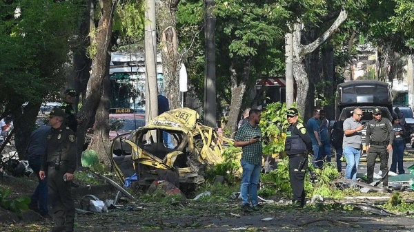 Members of the Colombian police inspect the area of a bomb explosion in Cali, Colombia on Thursday