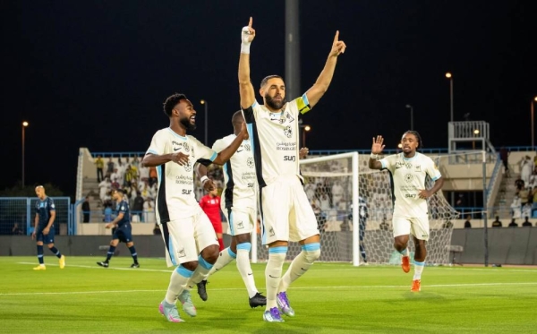 Al-Ittihad captain Karim Benzema gets the first of his three goals against Al-Okhdood. (SPL)