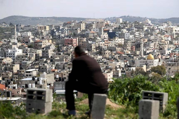 A man looks over the Nur al-Shams Refugee Camp, east of Tulkarm city in the occupied West Bank in March