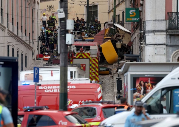Police and firefighters work on the site of a funicular railway accident in Lisbon, Portugal