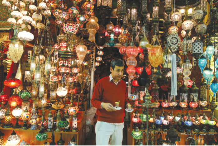 In this file photo a shop owner holds cups of tea outside his shop in Istanbul›s Grand Bazaar, one of Istanbul›s main tourist attractions. Turkey›s economy is suffering in the face of a string of militant attacks - including the  massacre of New Year’s revelers, most of them foreigners - and uncertainty following the failed coup in July against President Recep Tayyip Erdogan that saw more than 270 people killed. — AP