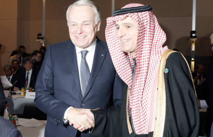 French Minister of Foreign Affairs Jean-Marc Ayrault (L) shakes hands with Saudi Foreign Minister Adel Al-Jubeir during the opening of the Mideast peace conference in Paris on Sunday. — AFP